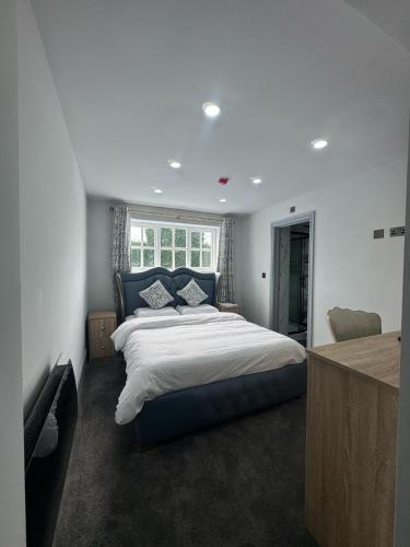 a bedroom with a large bed and a window at The Old Court House in Kingswinford