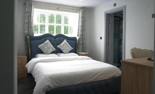 a bedroom with a large bed and a window at The Old Court House in Kingswinford