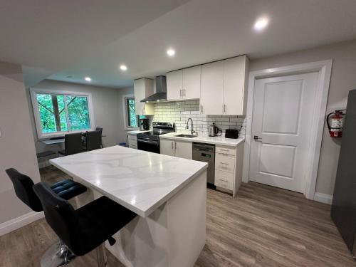 a kitchen with white cabinets and a white counter top at Luxurious Pvt room & Pvt heated floor bathroom near Airport in Kitchener