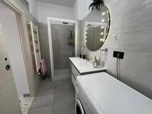 a white bathroom with a sink and a mirror at A casa di Alida in Cotulo