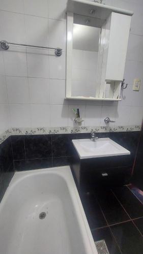 a bathroom with a bath tub and a sink at El Cerrito del Valle in Santa María
