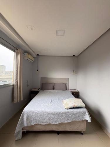 a bedroom with a bed and a window at Casa completa para cop 30 in Belém