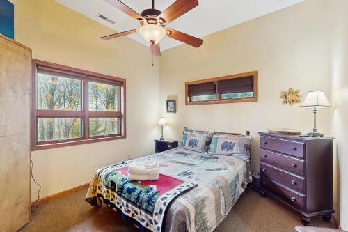 a bedroom with a bed and a ceiling fan at Eagle Rock in Beech Mountain