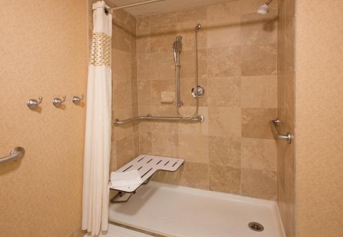 a bathroom with a shower with a tub and a shower curtain at Wingate by Wyndham Cranberry in Cranberry Township