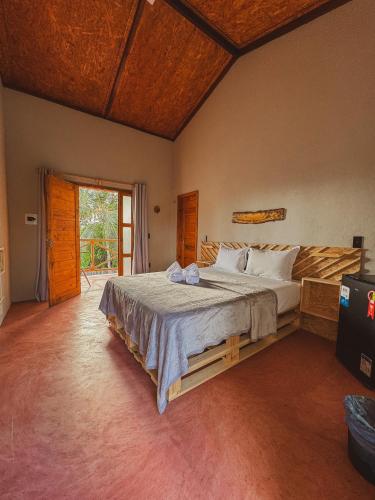 a bedroom with a large bed in a room at Windland Pousada Kite Center in Icaraí