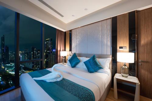 a hotel room with a bed with a swan on it at Imperial Luxury Suites KLCC by Moonway in Kuala Lumpur