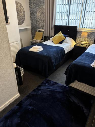 a hotel room with two beds and a window at The Georgian Guesthouse in Alnwick