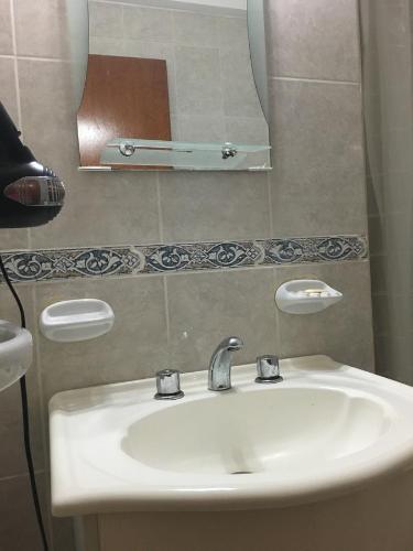 a bathroom with a sink and a mirror at Apartamento Los Abuelos in Colón