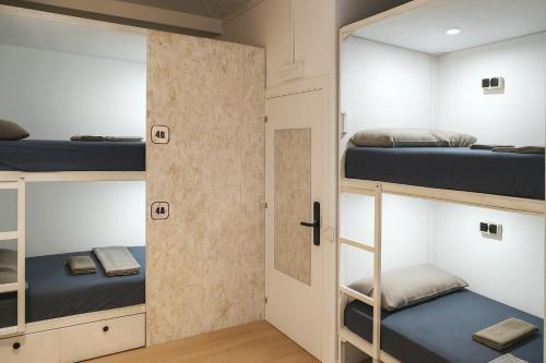 a room with bunk beds and a door at Modular Dreams in Madrid