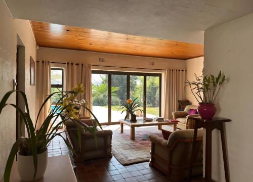 a living room with chairs and a table with plants at Stone Trading Pty Ltd in Durban