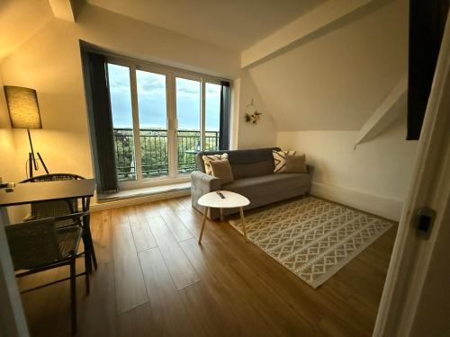 a living room with a couch and a table at 2 Bedroom Scenic Apartment, with Balcony View & Parking in Shipley
