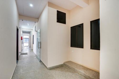 a hallway in a building with paintings on the walls at Hotel O Starlight Stay Jaipur International Airport in Jaipur