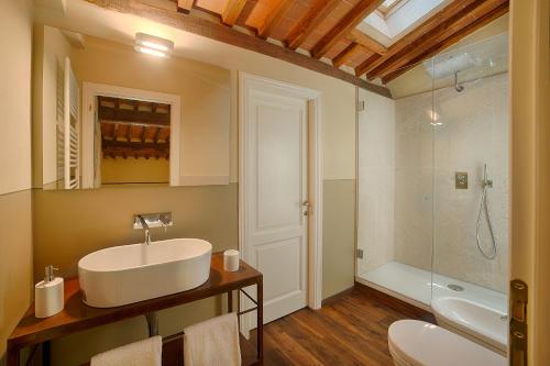 a bathroom with a sink and a toilet and a shower at Chianti B&B Design infinity pool shared in Pianella