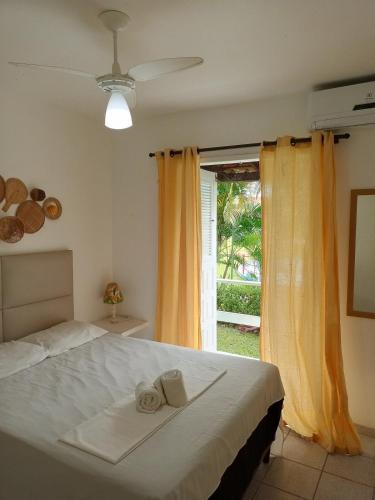 a bedroom with a bed with two towels on it at Golden Dolphin Taperapuan Apt 529 in Porto Seguro