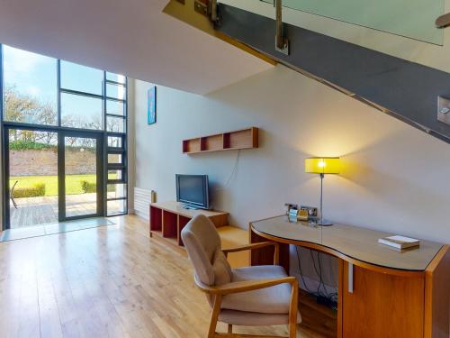 an attic office with a desk and a chair at Castlemartyr Holiday Lodges 3 Bed by Trident Holiday Homes in Castlemartyr