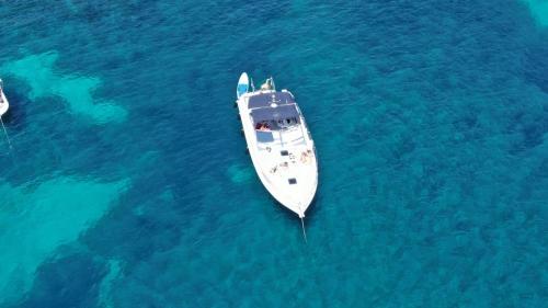 a white boat in the middle of the water at Boat with Jacuzzi - Bateau avec Jacuzzi in Mandelieu-la-Napoule