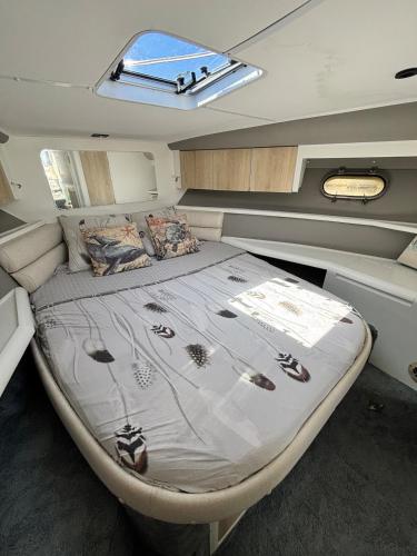 a bed in the back of a boat at Boat with Jacuzzi - Bateau avec Jacuzzi in Mandelieu-La Napoule