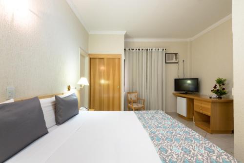 Una cama o camas en una habitación de Hotel Guarany