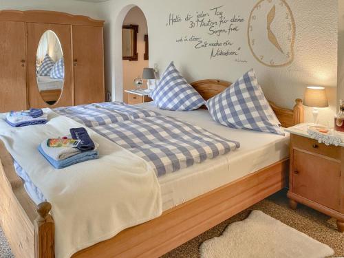 a bedroom with a bed with blue and white pillows at Landhaus Bez III in Schleyreuth