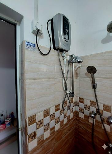 a shower in a bathroom with a camera on the wall at Breeze Blows- Solitude Holiday Home in Matara