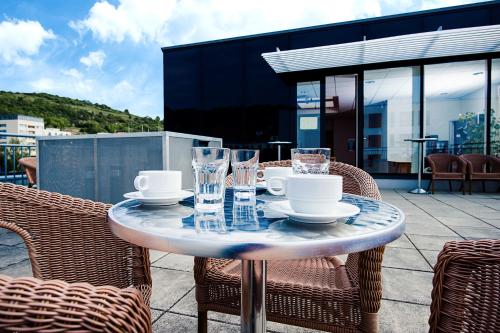 a table with plates and glasses on a patio at Kolping Campus Krems in Krems an der Donau
