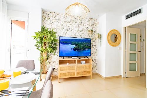 a living room with a flat screen tv on a wall at Avenida Principal junto a la Playa - by Aloha Palma in Águilas