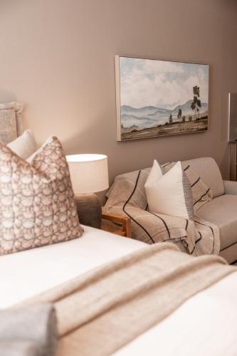 a living room with a couch and a chair at 222 at Maine in Pretoria