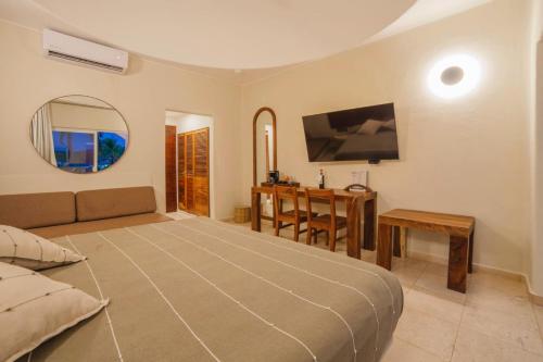 Postel nebo postele na pokoji v ubytování Quinta Bella Huatulco