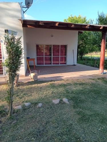 a small tree in front of a house at Casa de campo Luisa in Tinogasta