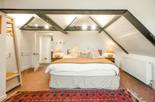 a bedroom with a large bed in a attic at Stylish Lewes Apartment - Gorgeous Views in Lewes