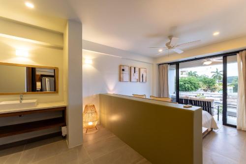 a bathroom with a bed and a sink and a mirror at 3062 - Solana C203 in Cedro