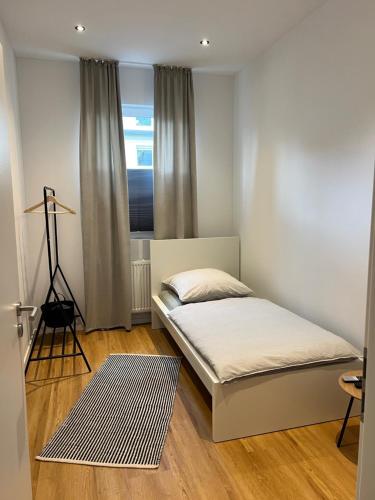 a small bedroom with a bed and a window at Zentral gelegen in Haan - 4 Schlafzimmer- Bis zu 7 Personen in Haan