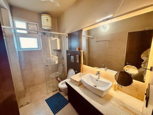 a bathroom with a sink and a shower and a toilet at MG Luxury Stays - Entire 4 BHK in Panchkula