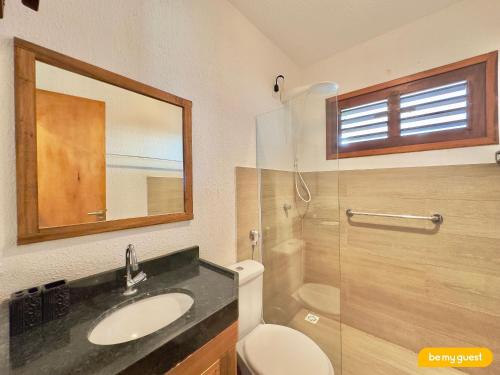 a bathroom with a sink and a toilet and a mirror at Reserva Retirinho B in Aracati