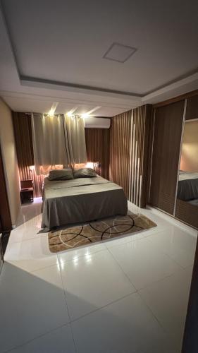 a bedroom with a bed with a rug on the floor at Casa centro in Porto Seguro