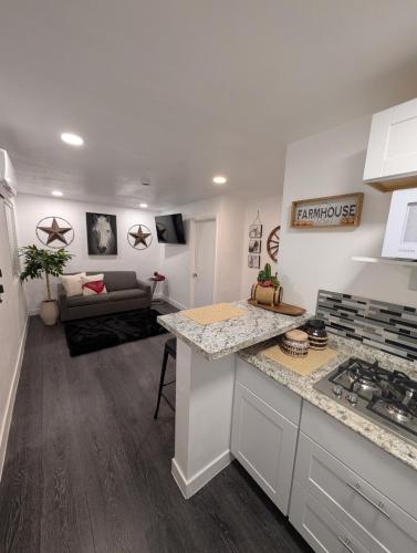 a kitchen and living room with a couch in the background at Rancho Las Casitas in Tucson
