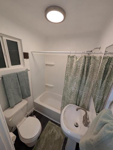 a bathroom with a sink and a toilet and a shower at Rancho Las Casitas in Tucson