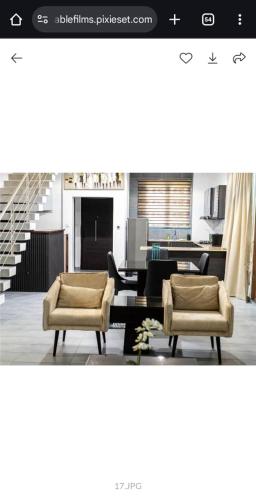 a living room with two chairs and a table at Emerald harbor apartments in Lekki