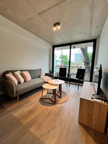 a living room with a couch and a table at Link in Montevideo