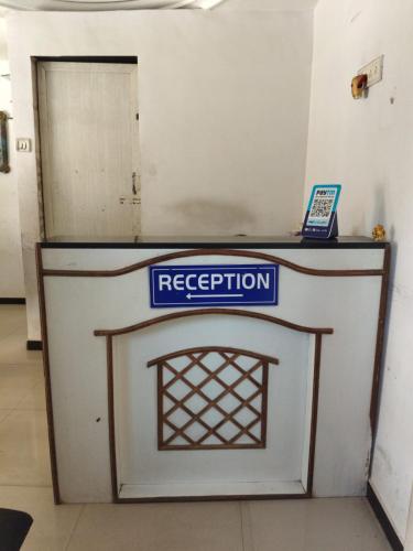 a white door with a sign on top of it at Hotel Dream in Rajkot