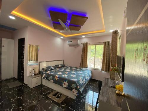 a bedroom with a bed and a purple ceiling at BFMS Villa, Royal Purandar in Purandhar