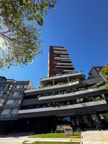 a tall building with plants on the side of it at LIV apto 1211 - Loft novo com vista in Porto Alegre