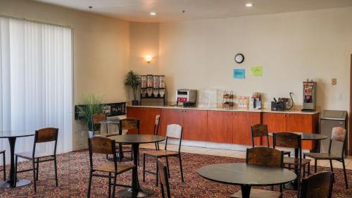 a restaurant with tables and chairs and a counter at Country Inn Ontario in Ontario