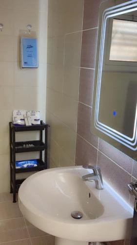 a bathroom with a white sink and a window at Apartment ready for daily rent Quiet, two bedrooms in Al Madinah