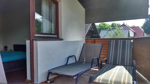a balcony with a chair and a bed and a window at Haus Ruf in Windischgarsten