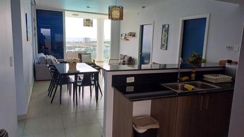 a kitchen with a sink and a table with chairs at Luz de Laguna in Playa Blanca