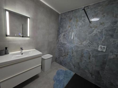 a bathroom with a sink and a shower at Bello in Wallerfangen