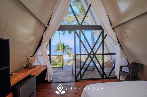 a room with a view of the ocean from a tent at Shambhala Holistic Resort Only Adults in Manzanillo