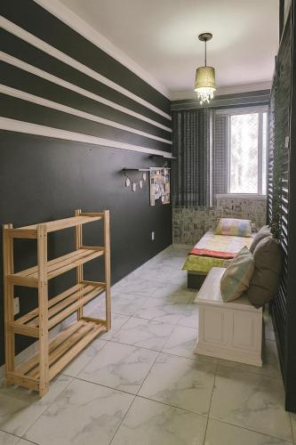a bedroom with striped walls and a bed and a table at Apartamento COP30 Praça da República e Teatro da Paz in Belém