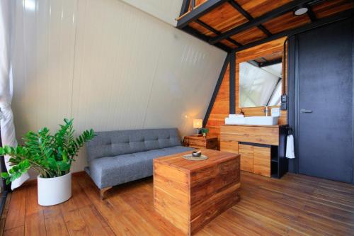 a living room with a couch and a table at Shambhala Holistic Resort Only Adults in Manzanillo